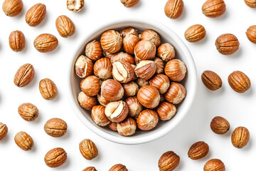 Hazelnuts in a white bowl on a white background