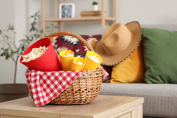 Wicket basket with popcorn on coffee table in living room. Festa Junina celebration