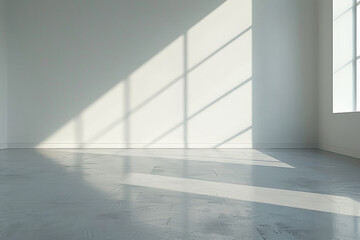 Obraz premium A large empty room with a window that is letting in sunlight. The room is bare and empty, with no furniture or decorations. The sunlight is shining through the window, creating a warm