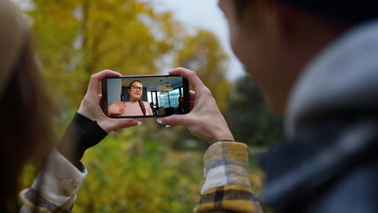 Girl videocalling friends couple closeup. Cute teenager waving cellphone screen