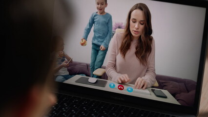 Joyful family talking webcam closeup. Unknown boy waving screen with little hand