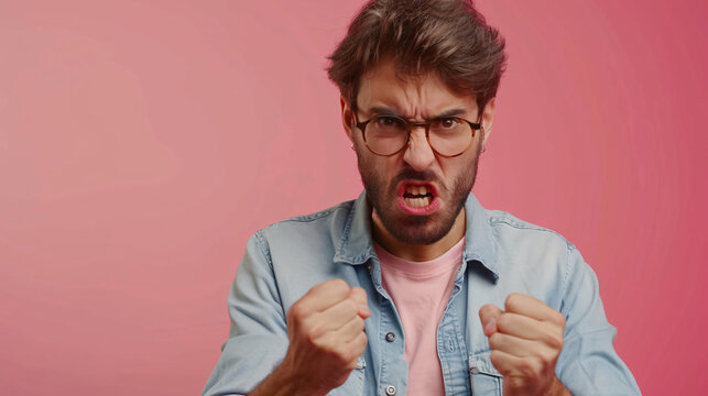 handsome man anggry look camera gesture pinkk background