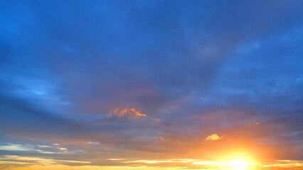 A magnificent sunrise with the sun casting a golden glow over the horizon. The sky transitions from...