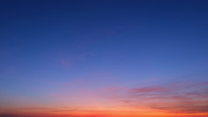 A beautiful gradient sky transitioning from deep blue at the top to vibrant orange and pink hues...