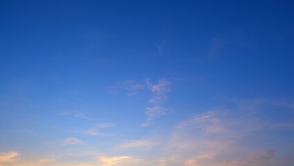 A serene evening sky transitioning from deep blue at the top to lighter hues towards the horizon....