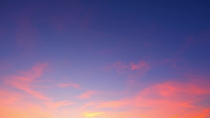 A vibrant sunset sky transitioning from deep blue at the top to soft pinks and purples. Wispy...