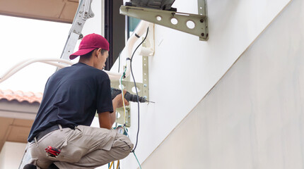 Technician man install new air conditioning, Repairman service for repair and maintenance of air conditioners