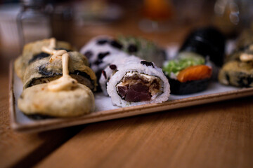 Assorted sushi rolls on a serving plate
