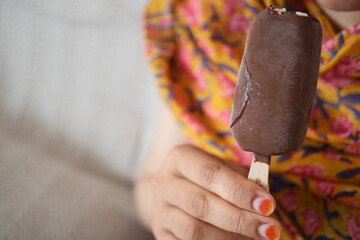 young women eating chocolate flavor ice cream 