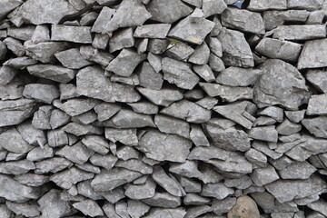 Old rural wall of rocks showing natural stone patterns