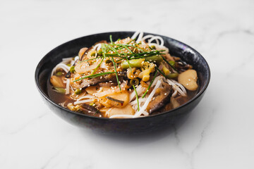 asian inspired rice noodle soup with green beans eggplant and water chestnuts