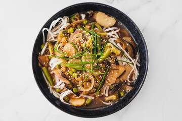 asian inspired rice noodle soup with green beans eggplant and water chestnuts