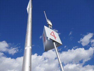 Communications antenna with number four with blue sky and clouds background