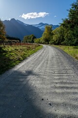 Country road and southern Alps mountain rage leading to Mt Aspiring, Wanaka, Otago, New Zealand.