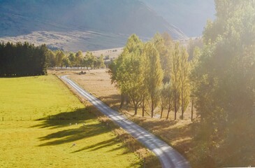 Country road and southern Alps mountain range leading to Mt Aspiring, Wanaka, Otago, New Zealand.