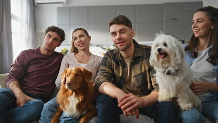 Group friends relaxing dogs at cozy living room close up. People sitting couch 