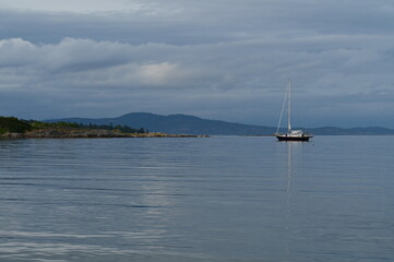 Fototapeta premium Serene scenery with a boat in the ocean