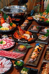 Cropped Image Of Hand Taking Sauce from sukiyaki shabu shabu japanese food buffet.