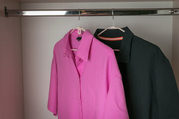 Pink and Black Shirts on Hangers in a Closet - Casual and Formal Attire