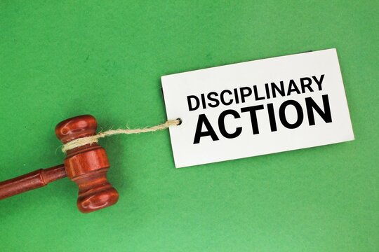 paper tag and judge's gavel with the word disciplinary action. the concept of disciplinary action. disciplined concept. attitude concept
