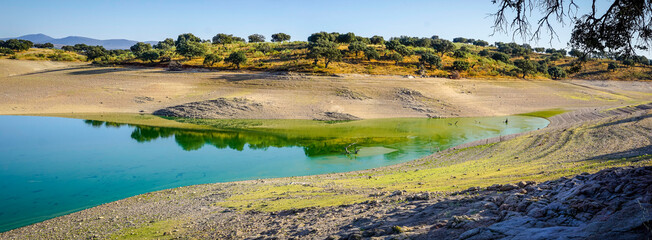 reflections in the water of the Valdecañas reservoir in Extremadura