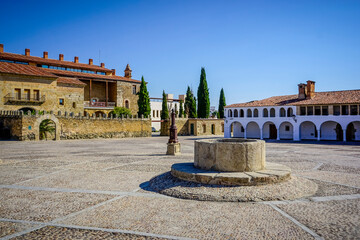 Stone arches with whitewashed walls in the main square of the Cáceres town of Garrovillas de...