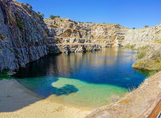 La Cantera natural pool, located next to the Roman bridge of Alcántara, this wild pool, limited by a stepped granite wall, is surrounded by the unique nature of the Tajo Internacional Natural Park, an