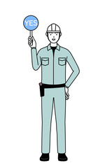 Man in helmet and workwear holding a maru placard that shows the correct answer.