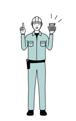 Man in helmet and workwear holding a calculator and pointing.