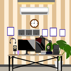 A work room with a tablet computer, headphones, monitor and other equipment fully equipped for work.