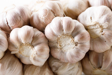 Ripe organic garlic clove and bulb on white wooden background.  Close-up. Selective focus.