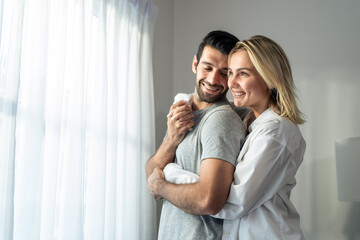 Caucasian young couple spend free leisure time together in living room.