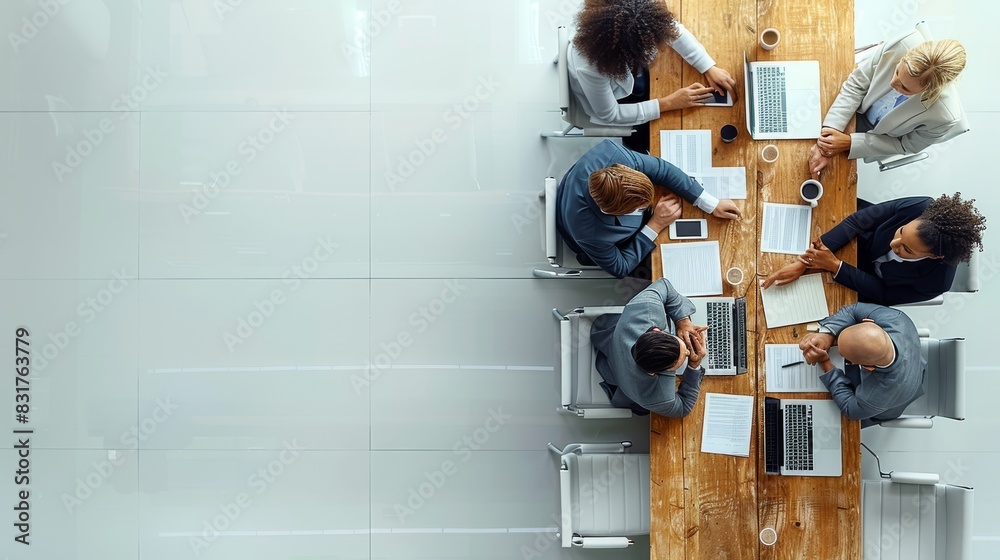 Aufkleber a professional business meeting setting with people in formal attire, laptops, and documents on a wh