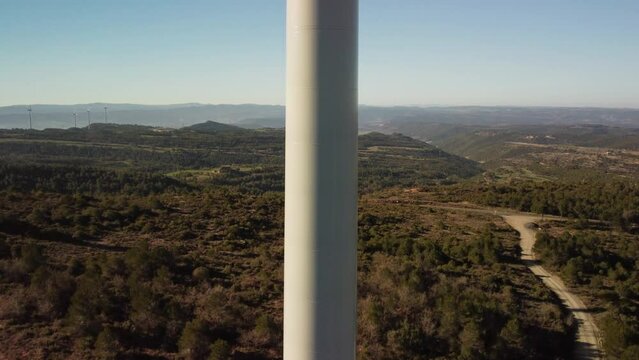 A wind turbine in Igualada, Barcelona with scenic hills and clear skies