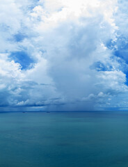 Naklejka premium Blue sky with clouds and sea Aerial view. background with shining sun and white fluffy clouds summer season sea outdoor.