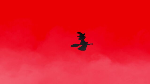 Halloween animation black witch flying on broomstick over foggy background Red