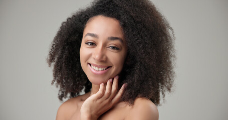 Beauty and healthcare concept - beautiful African American woman with curly afro hairstyle and...