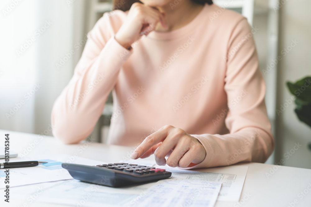 Canvas Prints Deduction planning concept. Asian young woman hand using calculator to calculating balance prepare tax reduction income, cost budget expenses for pay money form personal Individual Income Tax Return