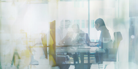 A dynamic double exposure of business individuals bustling in a contemporary office environment.