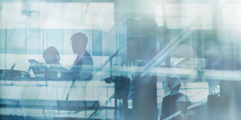 A double exposure image showing business people working in an office setting.