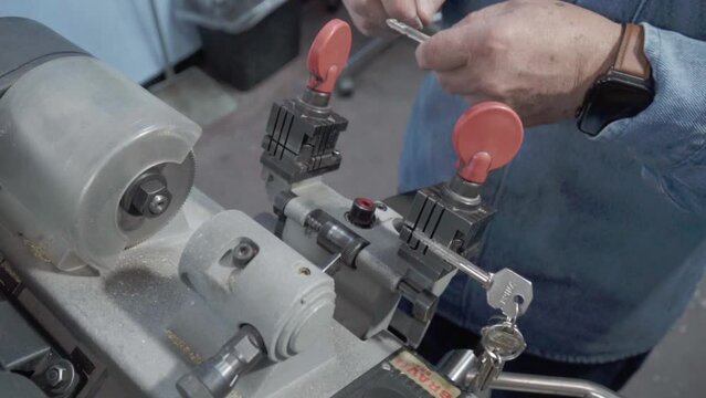 Key maker working with their machines while testing them