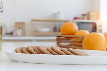 Freshly baked homemade cookies in plate on counter at home kitchen, sweet cookie with blurred...