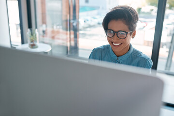 Creative woman, happy and reading on computer for online planning, email or startup news in office....