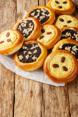 Kolache are a sweet Czech pastry made of yeast dough stuffed with homemade cottage cheese or poppy seeds closeup on the wooden table. Vertical