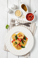 italian pasta mezzelune on a plate, top view