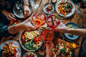 Friends Celebrating with Colorful Cocktails and a Feast of Fresh Dishes