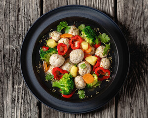 chicken meatball soup with vegetables in a bowl