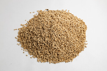 pile of wood pellets for heating with human hand white background
