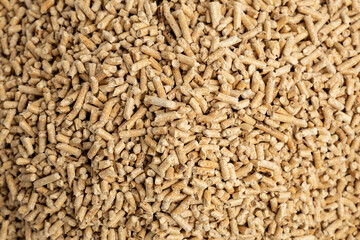 pile of wood pellets for heating with human hand white background