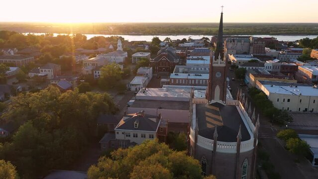 Natchez, Mississippi, USA - April 21, 2024: Sunset light shines on a historic church and landscape of downtown Natchez.